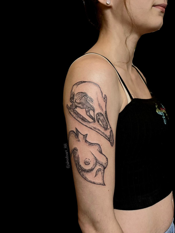 Upper arm tattoo of a horse skull with a naked woman bust tattooed by Sacred Mandala Studio artist Lita Almodovar.
